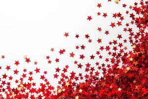 shiny red and gold stars are scattered on a white surface, photo