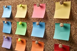a bulletin board with colored paper pinned to it, photo