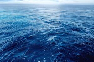 beautiful blue water with bright white sun reflecting over it, photo