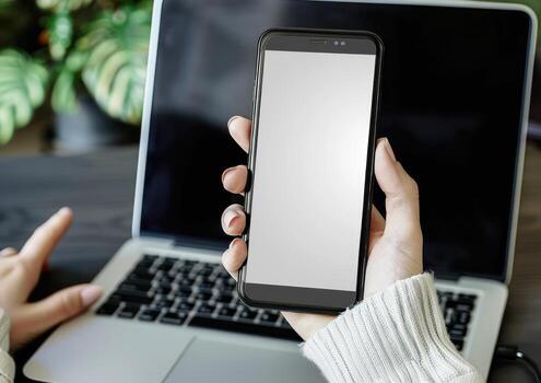 someone using a cell phone is holding the white screen, photo