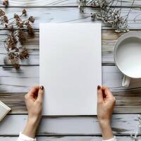the hands are holding the paper for your design, photo