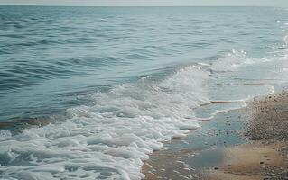 a man standing next to the shore on a beach, photo