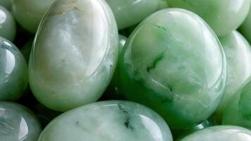 a pile of jade stones on a wooden table, photo