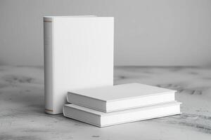 three small book sitting next to a larger white books, photo