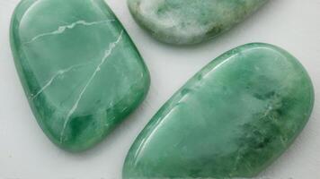 three stones are cut to look like green jade, photo