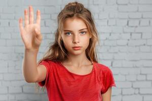 a young girl with shoulder folded in the air as she holds her hand up, photo