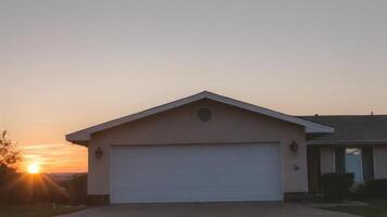a house that has the sun setting up, photo