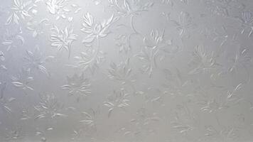 an odd window with a pattern made out of frost, photo
