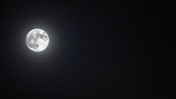 a full moon set on a cloudy night, photo