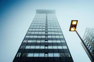the streetlight is glowing near an illuminated tower, photo
