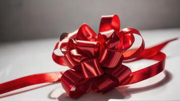 a red ribbon is rolled in a big bow, photo