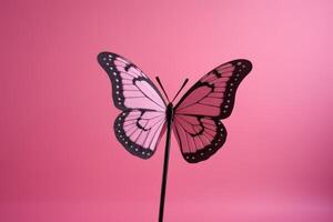 pink and black butterfly stuck in a pink backdrop, photo