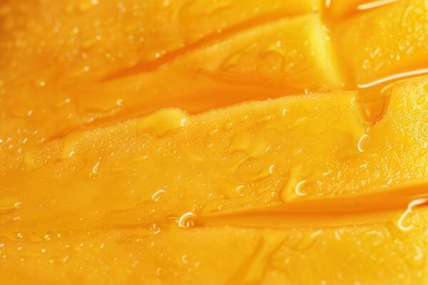 water droplets forming on a slice of mango fruit,
