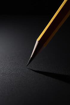 an image of a pencil with the tip pointing upward to the same person, photo