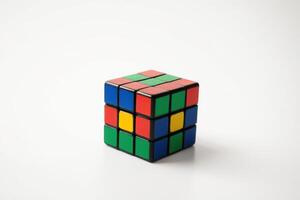 four colored cubes set on tables with two missing sides, photo