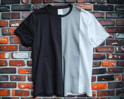 three different colored ts shirts on hang up against a brick wall, photo