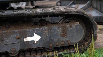 close-up of a crawler mini excavator driving through mud, ground after rain video