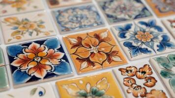 an assortment of decorative tile tiles sitting on a white floor, photo