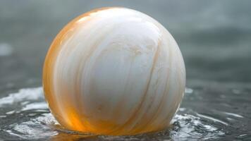a large golden ball is floating down some water, photo