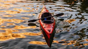 there is a red kayak that floats on the water, photo
