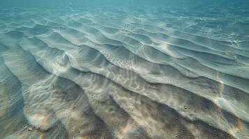 the ocean has ripples and smooth sand in it, photo