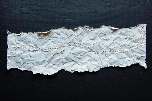 a torn piece of paper on dark background, photo