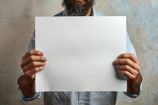 man frowning holding up blank paper in front of him, photo
