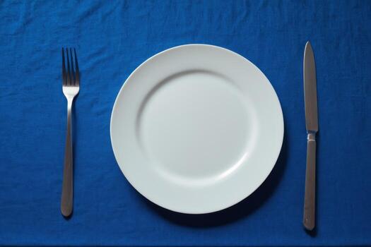 a plate with silverware placed on top of it, photo