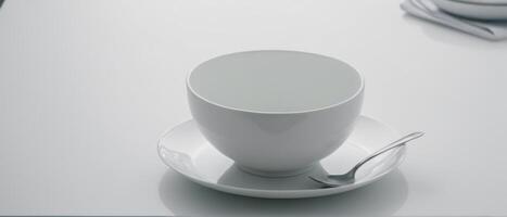 an empty mug sitting on top of a white saucer, photo
