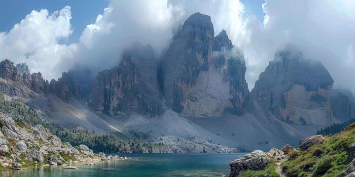 the mountains with a body of water is surrounded by green grass and rocks, photo