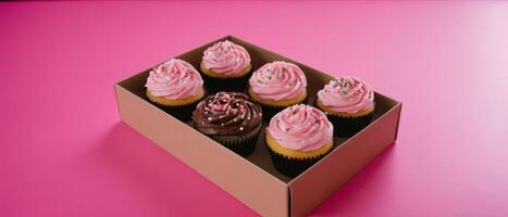 four dozen cupcakes in box on pink table, photo