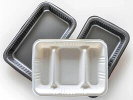 several empty, reclosied, silver and black baking cases, photo