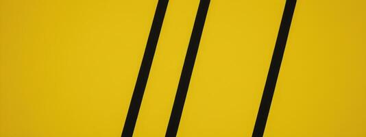 a pair of black lines near a yellow wall, photo