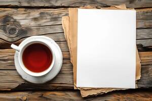 an open notepad sitting on top of a cup next to a tea, photo