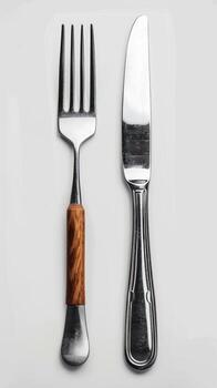 a fork and knife sitting on a table, photo
