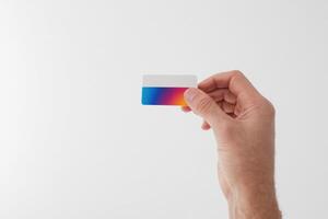 a person holding a business card with watercolor paper strips, photo