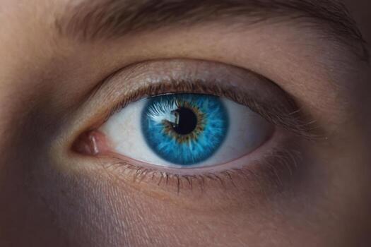blue eye with white iris is shown in this image, photo