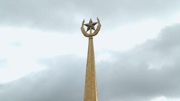 Top view of architectural star. Stock footage. Image of star on peak of building. Peak on top of building with star on cloudy sky background video