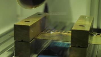 Close-up of burning laser machine at factory. Media. Laser that burns out dots on metal object. Laser burning machine at factory video