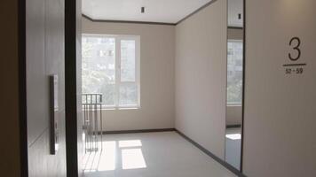 Modern entrance with white walls. Stock footage. Third floor of a modern new hall in a multi storey building. video