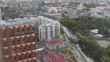 Beautiful landscape from a drone. Stock footage . A bright view of the office buildings located in the city center and a beautiful park with a river where tourists walk video