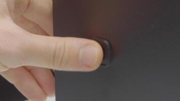 Close-up of pressing monitor start button. Action. Button for starting computer or electronic device. Finger presses computer power button video