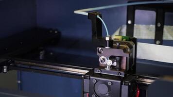 3D printer printing process. Media. Close up of 3d printing machine in motion at the factory workshop. video
