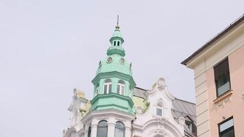 Low angle view of a beautiful building with light turquoise dome of a tower. Action. Concept of architecture, street of an old city. video