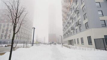 Winter yard . Action.Huge new buildings with blue shades with large snowdrifts around and lanterns are visible. video
