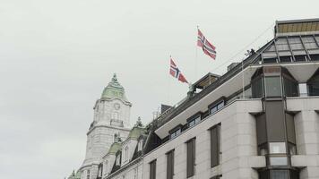 Low angle view of a beautiful building with waving flags on its roof. Action. Concept of classic architecture. video