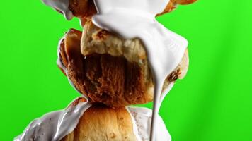 Pink and green background. Stock clip.Fresh baked pastries on a bright background that is watered with sugar syrup. video