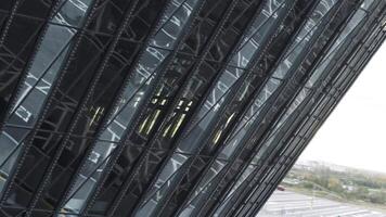 Close-up of facade of glass building with reflection. Stock footage. Top view of glass facade of building. Beautiful modern architecture of glass building video