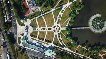 Top aerial view of a city park with a round shaped pond. Creative. Summer park with small paths and green trees. video