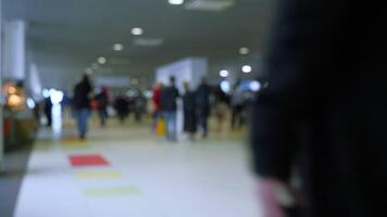 Defocused crowd at the exhibition center. Media. Blurred background with walking people inside the building. video